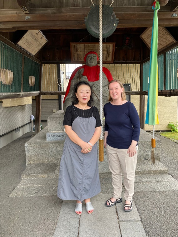 Author Sachiko Kashiwaba and translator Avery Udagawa with the Jizō on Honchō Dōri avenue in Morioka